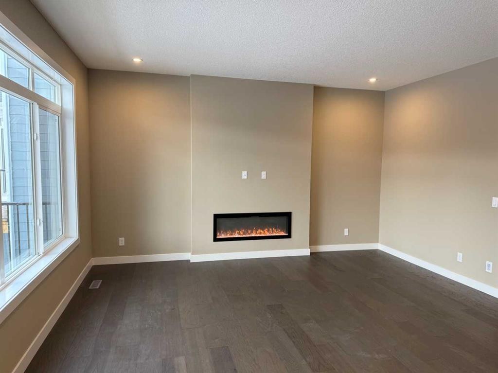 115 Sundown Crescent, Cochrane, AB - Indoor With Fireplace