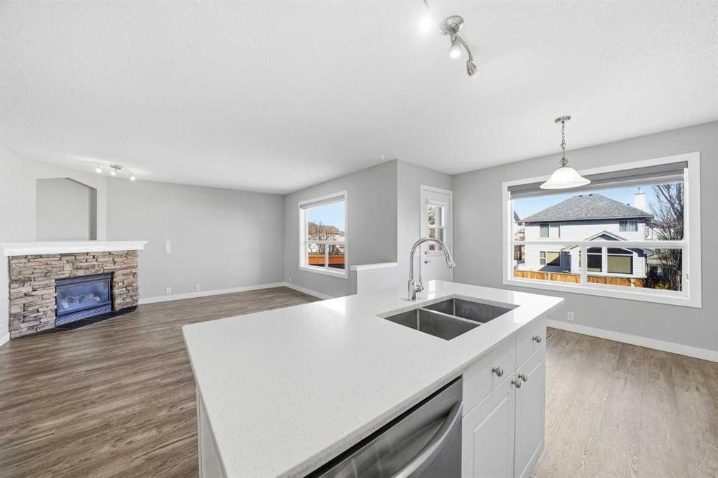 83 Cranfield Crescent Se, Calgary, AB - Indoor Photo Showing Kitchen With Fireplace With Double Sink