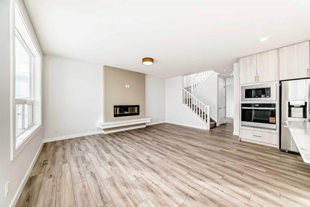 100 Corner Glen Manor Ne, Calgary, AB - Indoor With Fireplace
