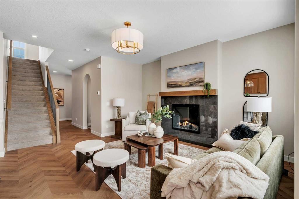 47 Sundown Crescent, Cochrane, AB - Indoor Photo Showing Living Room With Fireplace