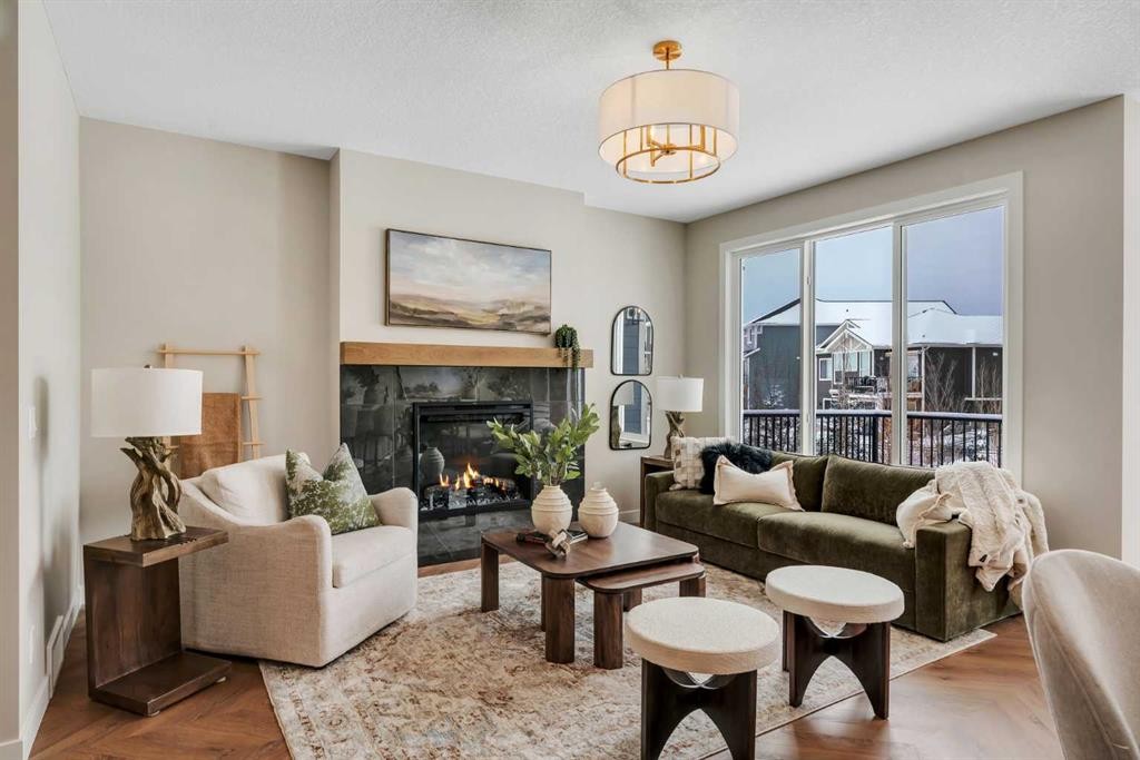 47 Sundown Crescent, Cochrane, AB - Indoor Photo Showing Living Room With Fireplace