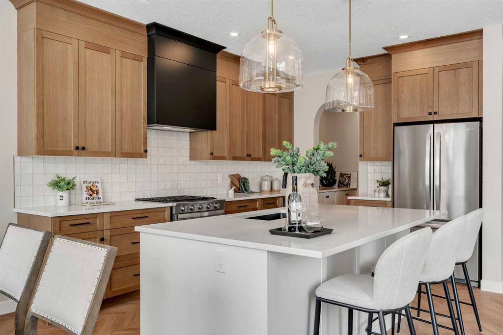 47 Sundown Crescent, Cochrane, AB - Indoor Photo Showing Kitchen With Upgraded Kitchen