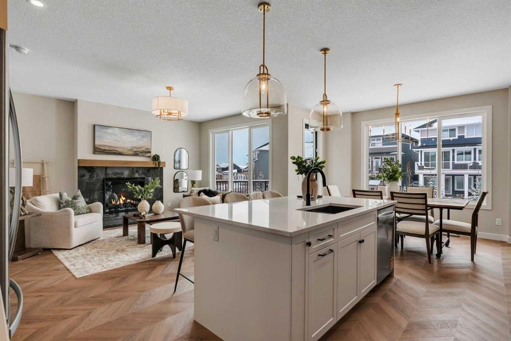 47 Sundown Crescent, Cochrane, AB - Indoor Photo Showing Kitchen With Fireplace