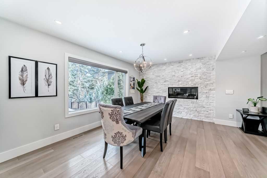 256 Riverside Mews Se, Calgary, AB - Indoor Photo Showing Dining Room With Fireplace