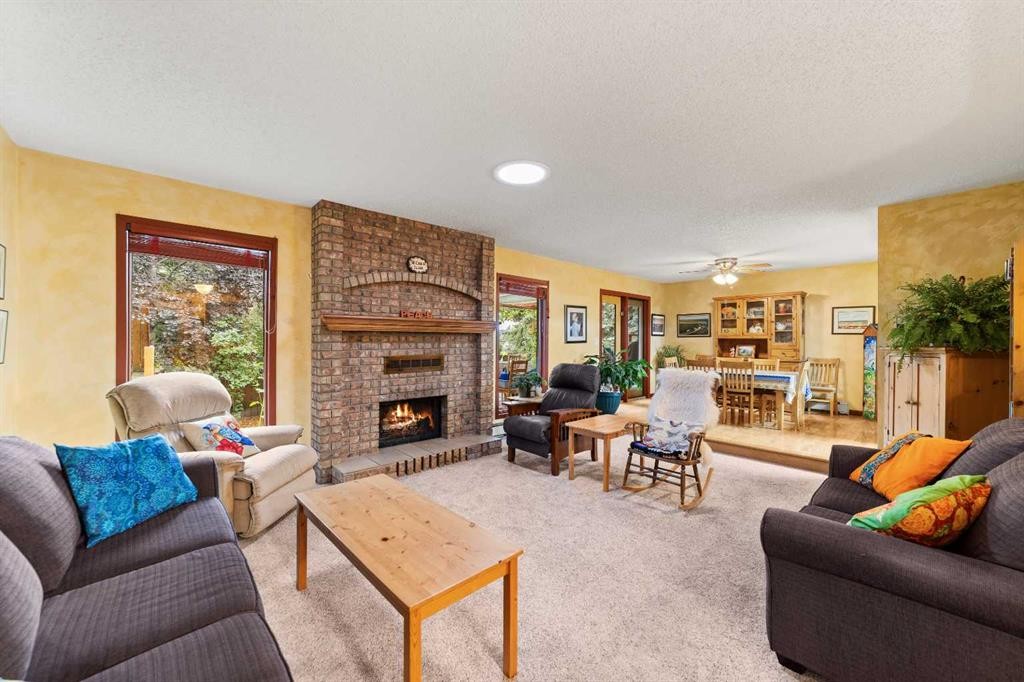 25 Westheights Drive, Didsbury, AB - Indoor Photo Showing Living Room With Fireplace