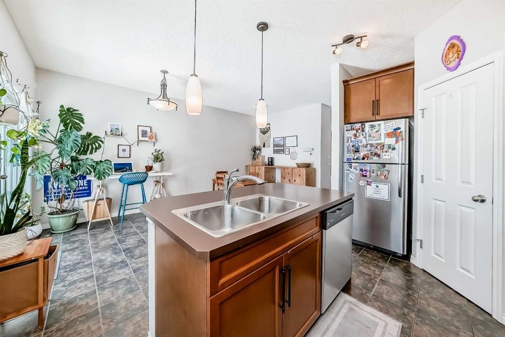 296 Sunset Point, Cochrane, AB - Indoor Photo Showing Kitchen With Double Sink
