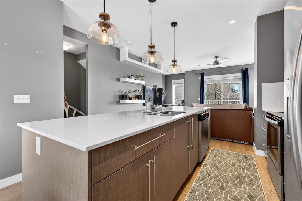 43-111 Rainbow Falls Gate, Chestermere, AB - Indoor Photo Showing Kitchen With Stainless Steel Kitchen With Double Sink With Upgraded Kitchen
