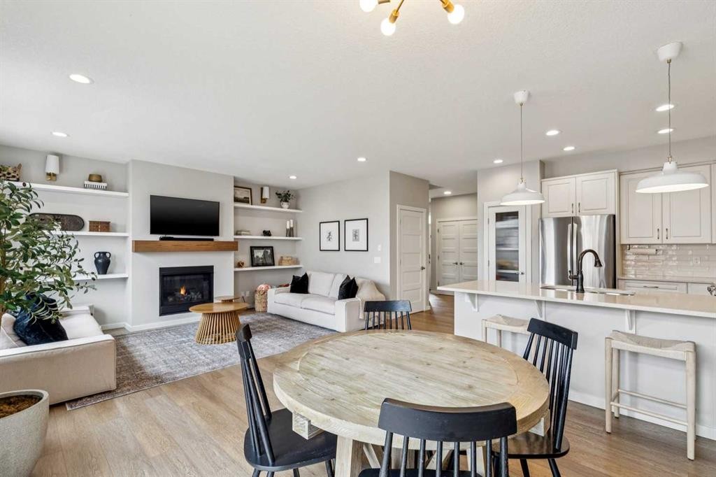 44 Legacy Landing Se, Calgary, AB - Indoor Photo Showing Dining Room With Fireplace