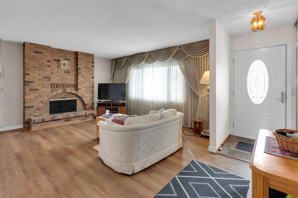 6004 Maddock Drive Ne, Calgary, AB - Indoor Photo Showing Living Room With Fireplace
