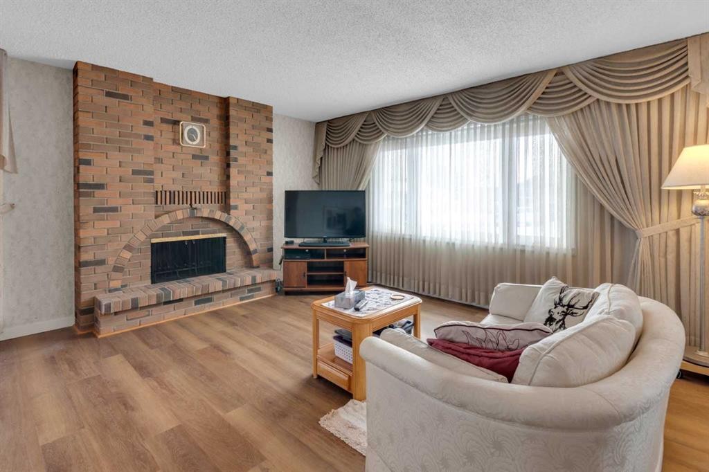 6004 Maddock Drive Ne, Calgary, AB - Indoor Photo Showing Living Room With Fireplace
