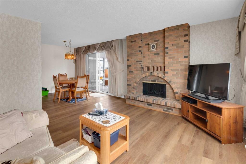 6004 Maddock Drive Ne, Calgary, AB - Indoor Photo Showing Living Room With Fireplace