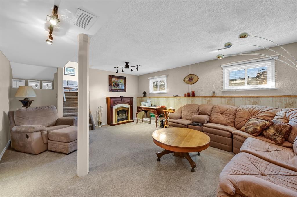36 Alpine Crescent Se, Airdrie, AB - Indoor Photo Showing Living Room With Fireplace