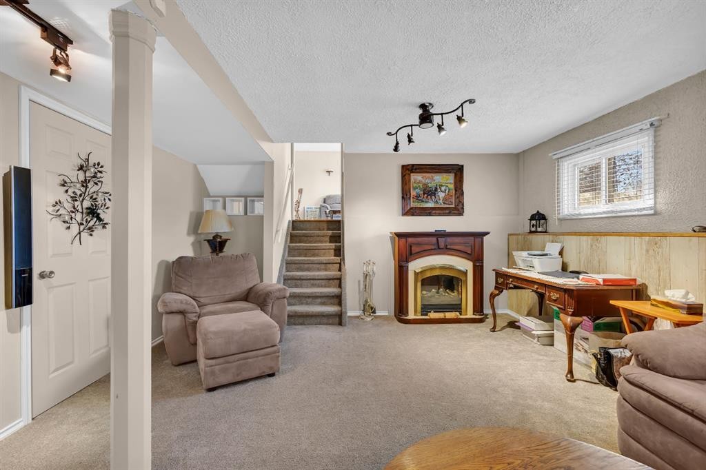 36 Alpine Crescent Se, Airdrie, AB - Indoor Photo Showing Living Room With Fireplace