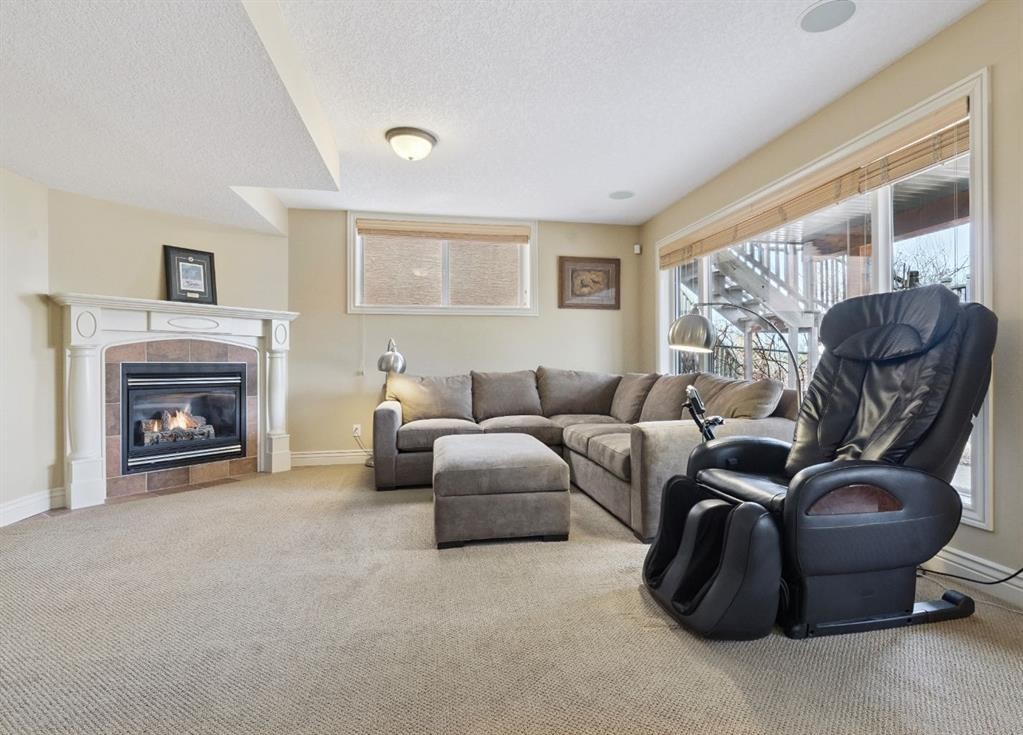 212 Springmere Place, Chestermere, AB - Indoor Photo Showing Living Room With Fireplace