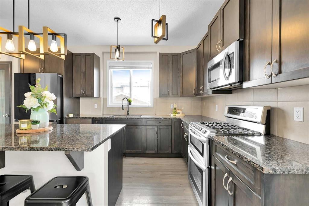151 Heritage Drive, Cochrane, AB - Indoor Photo Showing Kitchen With Upgraded Kitchen