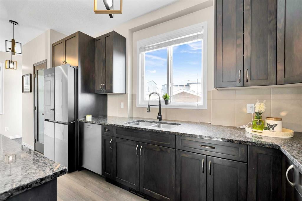 151 Heritage Drive, Cochrane, AB - Indoor Photo Showing Kitchen With Double Sink With Upgraded Kitchen