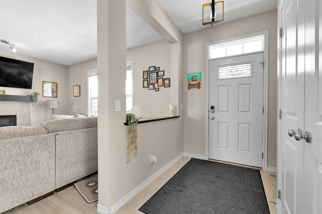 151 Heritage Drive, Cochrane, AB - Indoor Photo Showing Other Room With Fireplace