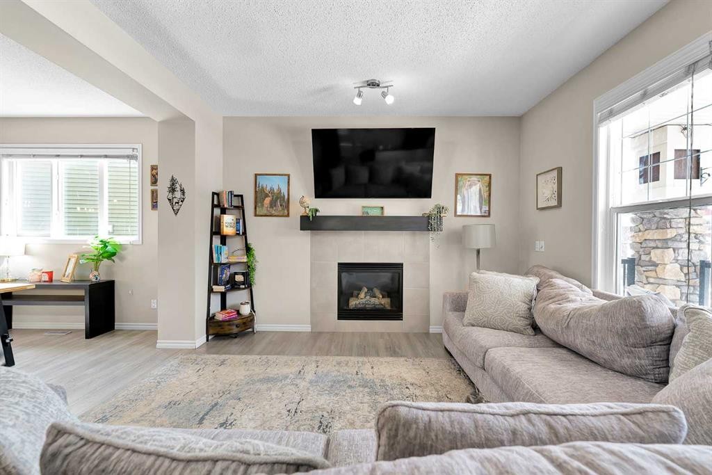 151 Heritage Drive, Cochrane, AB - Indoor Photo Showing Living Room With Fireplace