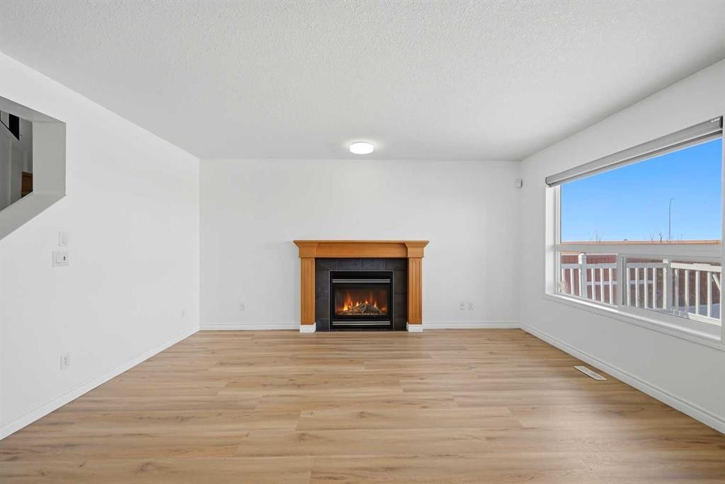 165 Saddlecrest Way Ne, Calgary, AB - Indoor Photo Showing Living Room With Fireplace