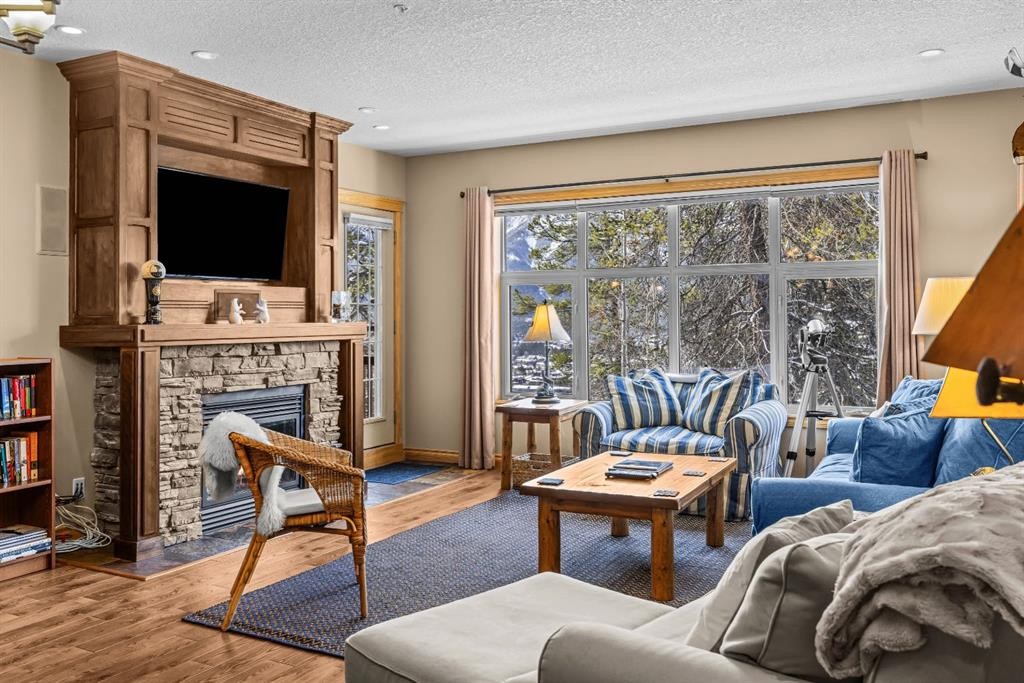 202-3 Aspen Glen, Canmore, AB - Indoor Photo Showing Living Room With Fireplace