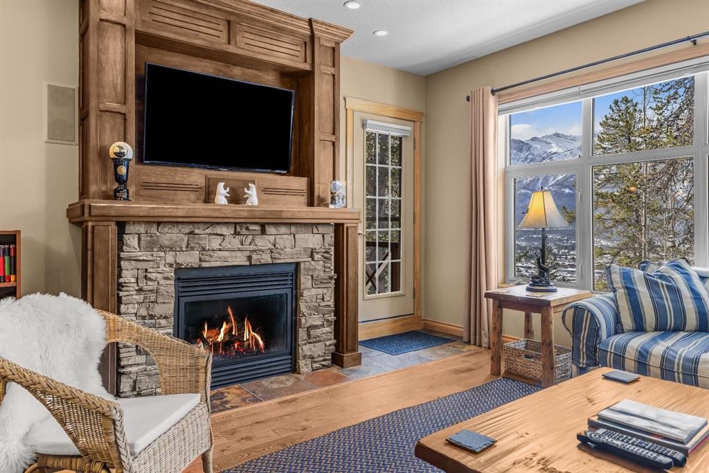 202-3 Aspen Glen, Canmore, AB - Indoor Photo Showing Living Room With Fireplace