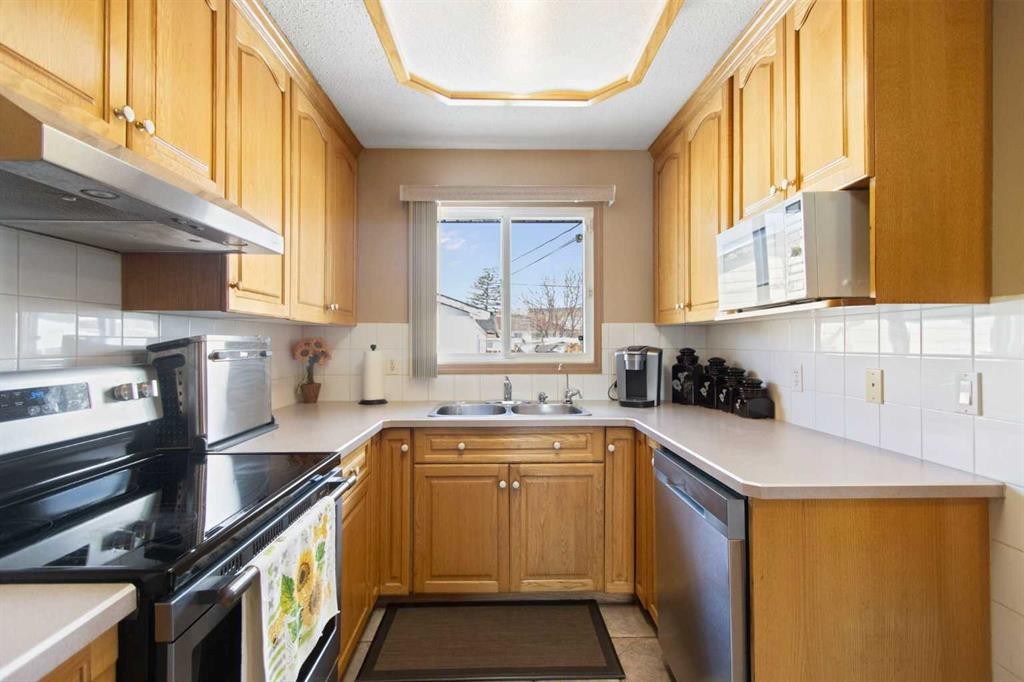 1108 Marcombe Crescent Ne, Calgary, AB - Indoor Photo Showing Kitchen With Double Sink