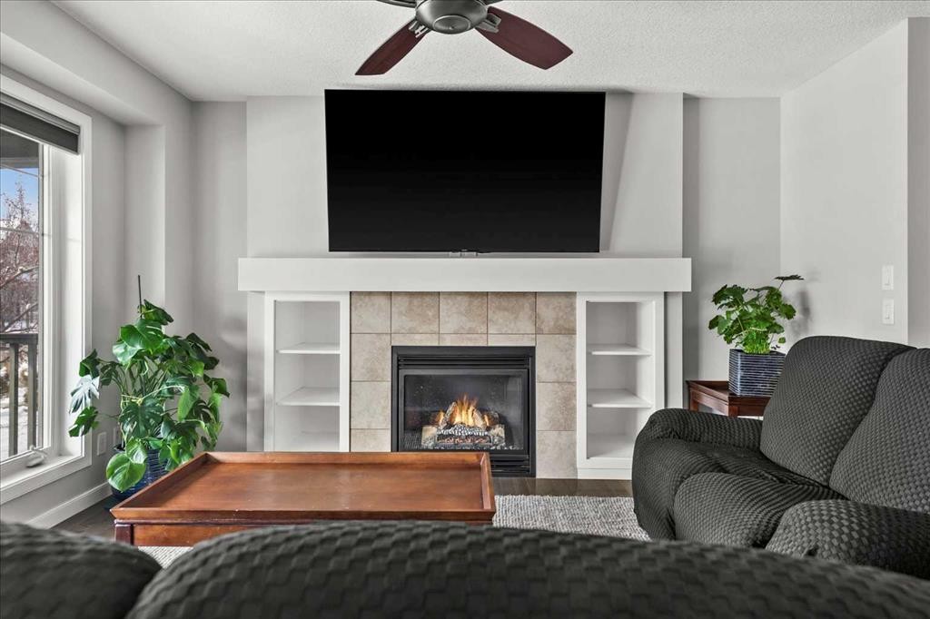 399 Copperpond Boulevard Se, Calgary, AB - Indoor Photo Showing Living Room With Fireplace