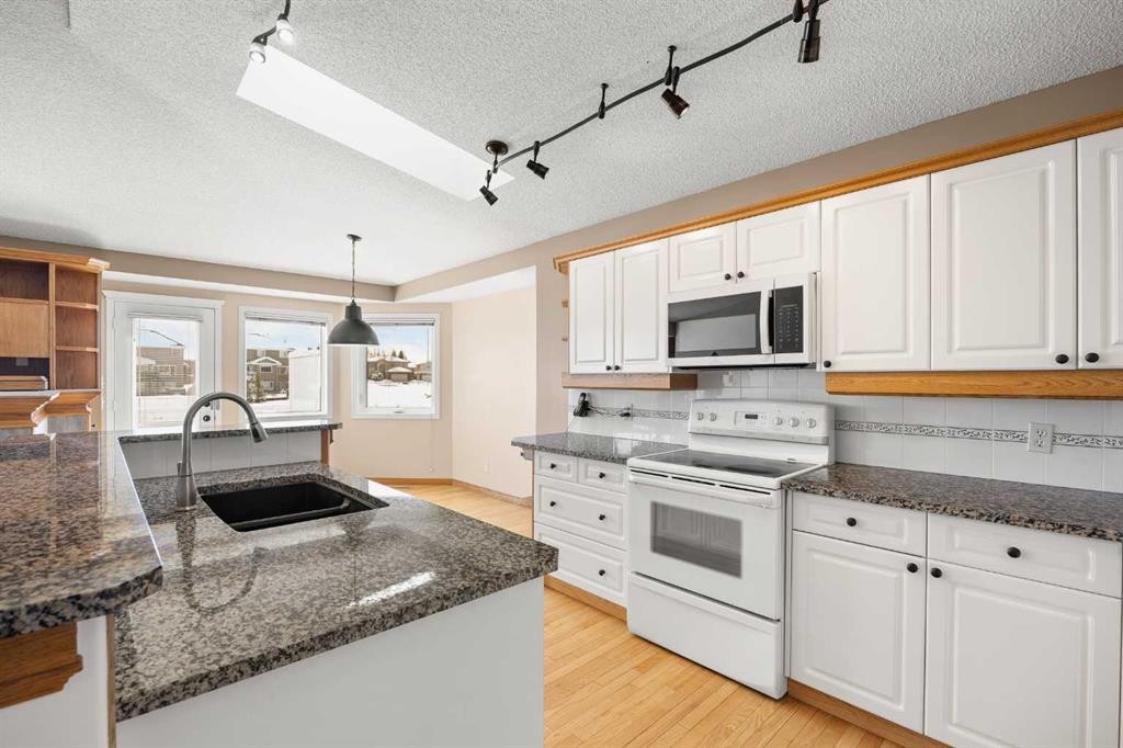8 Edgevalley View Nw, Calgary, AB - Indoor Photo Showing Kitchen With Double Sink