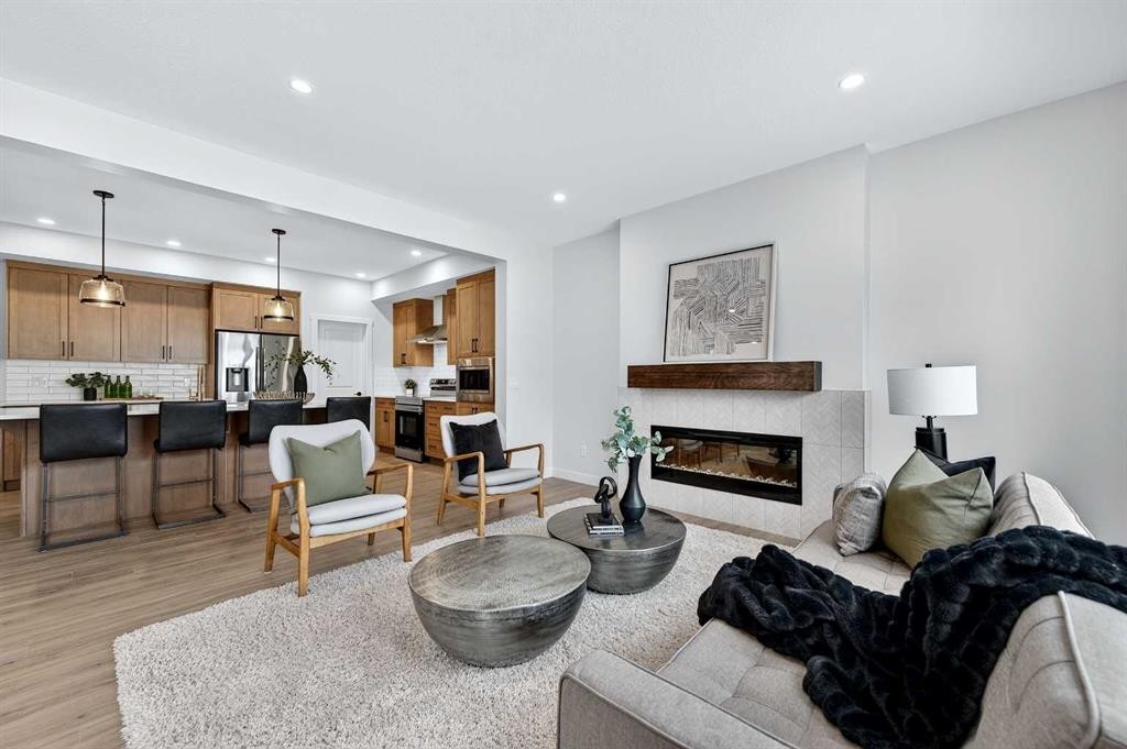 36 Lewiston Common Ne, Calgary, AB - Indoor Photo Showing Living Room With Fireplace
