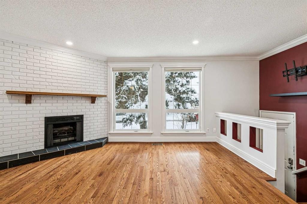 131 Woodglen Way Sw, Calgary, AB - Indoor Photo Showing Living Room With Fireplace