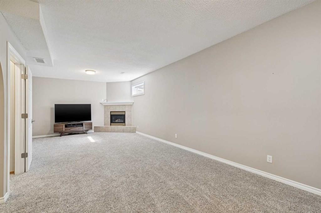 113 Westchester Way, Chestermere, AB - Indoor Photo Showing Other Room With Fireplace