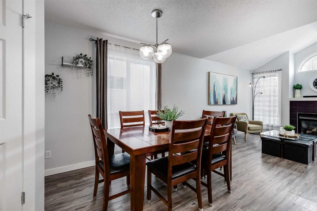 138 Prestwick Circle Se, Calgary, AB - Indoor Photo Showing Dining Room With Fireplace