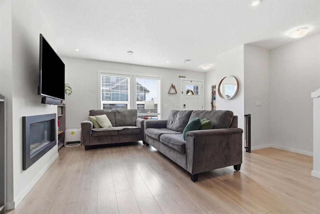 479 Cranbrook Square Se, Calgary, AB - Indoor Photo Showing Living Room With Fireplace