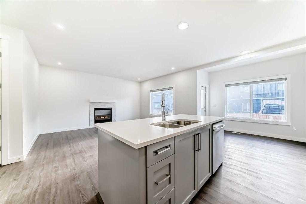 772 Edgefield Crescent, Strathmore, AB - Indoor Photo Showing Kitchen With Fireplace With Double Sink