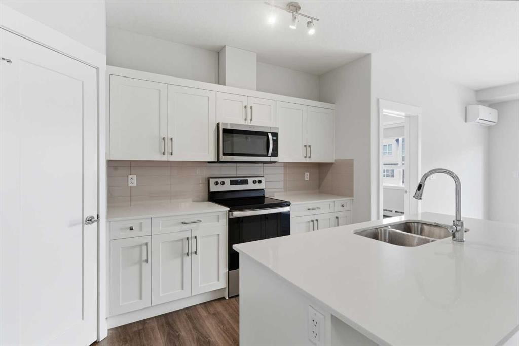 211-25 Walgrove Walk Se, Calgary, AB - Indoor Photo Showing Kitchen With Stainless Steel Kitchen With Double Sink