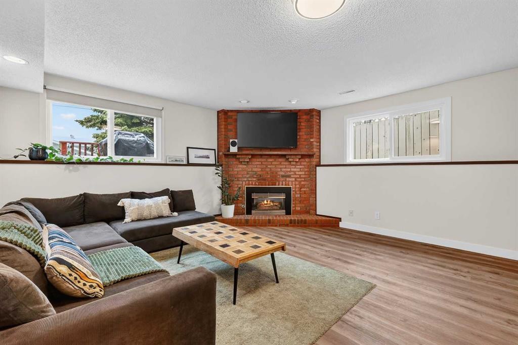 584 Woodhill Place Sw, Calgary, AB - Indoor Photo Showing Living Room With Fireplace