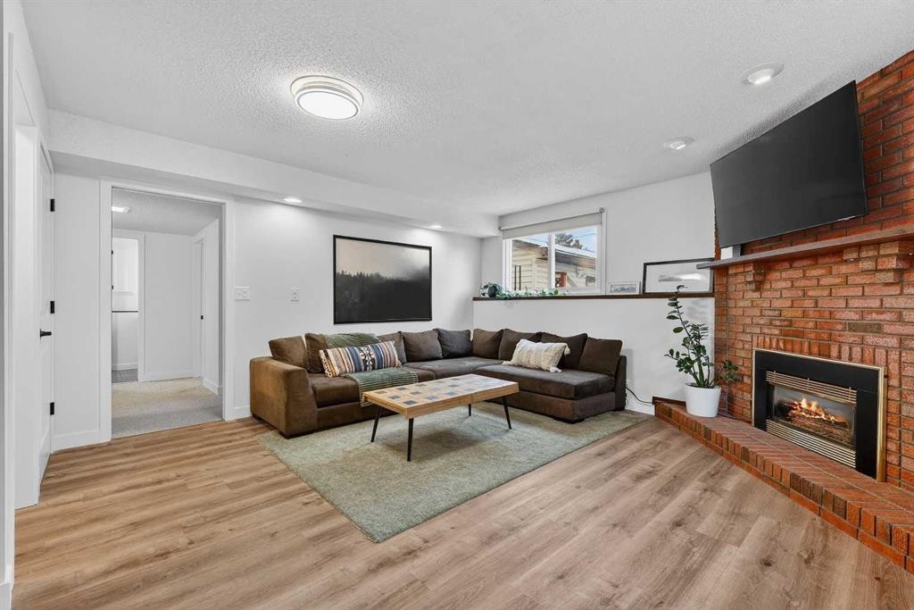584 Woodhill Place Sw, Calgary, AB - Indoor Photo Showing Living Room With Fireplace