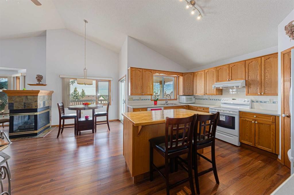 20 Somerset Drive Sw, Calgary, AB - Indoor Photo Showing Kitchen With Fireplace
