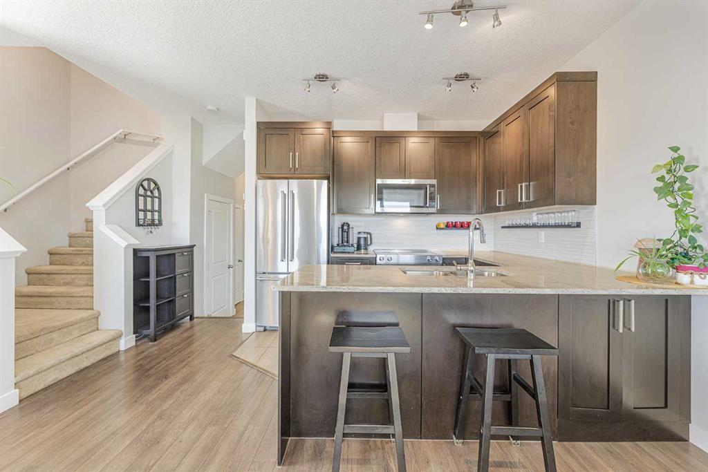 108 Jumping Pound Common, Cochrane, AB - Indoor Photo Showing Kitchen With Upgraded Kitchen