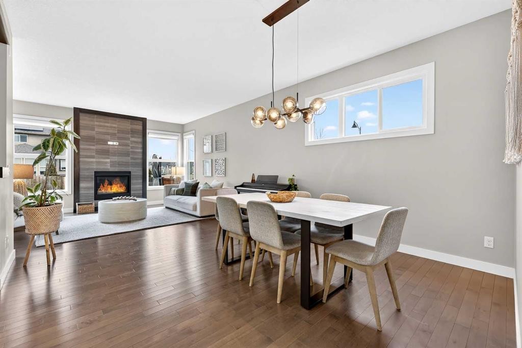 9 Legacy Lane Se, Calgary, AB - Indoor Photo Showing Dining Room With Fireplace