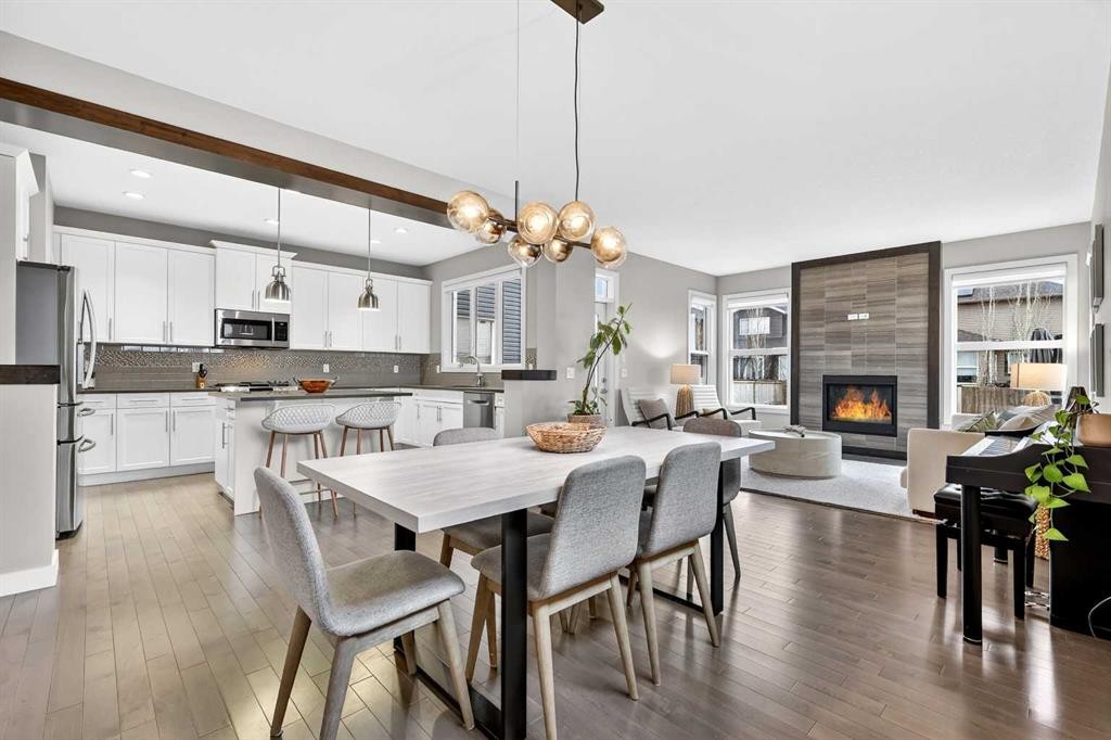 9 Legacy Lane Se, Calgary, AB - Indoor Photo Showing Dining Room With Fireplace