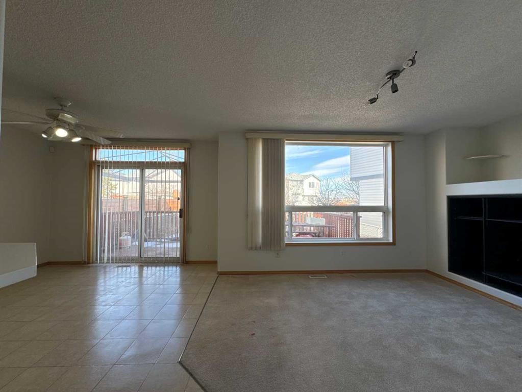 244 Los Alamos Place Ne, Calgary, AB - Indoor Photo Showing Other Room With Fireplace