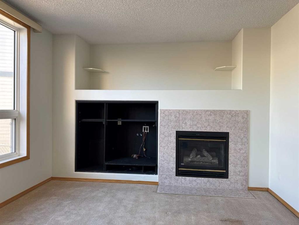 244 Los Alamos Place Ne, Calgary, AB - Indoor Photo Showing Living Room With Fireplace