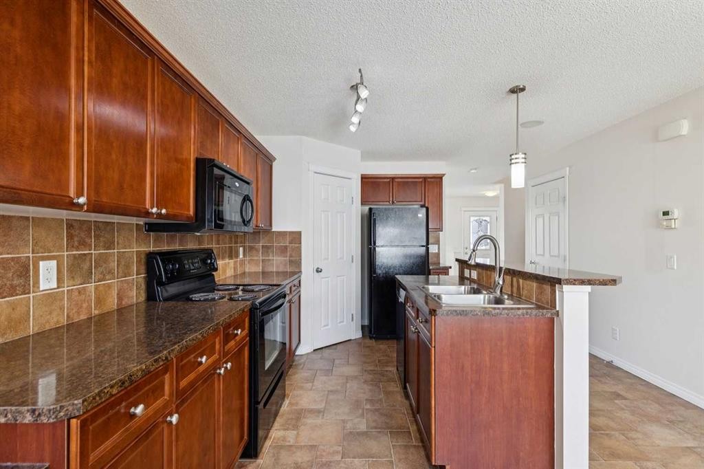 200 Silverado Drive Sw, Calgary, AB - Indoor Photo Showing Kitchen With Double Sink