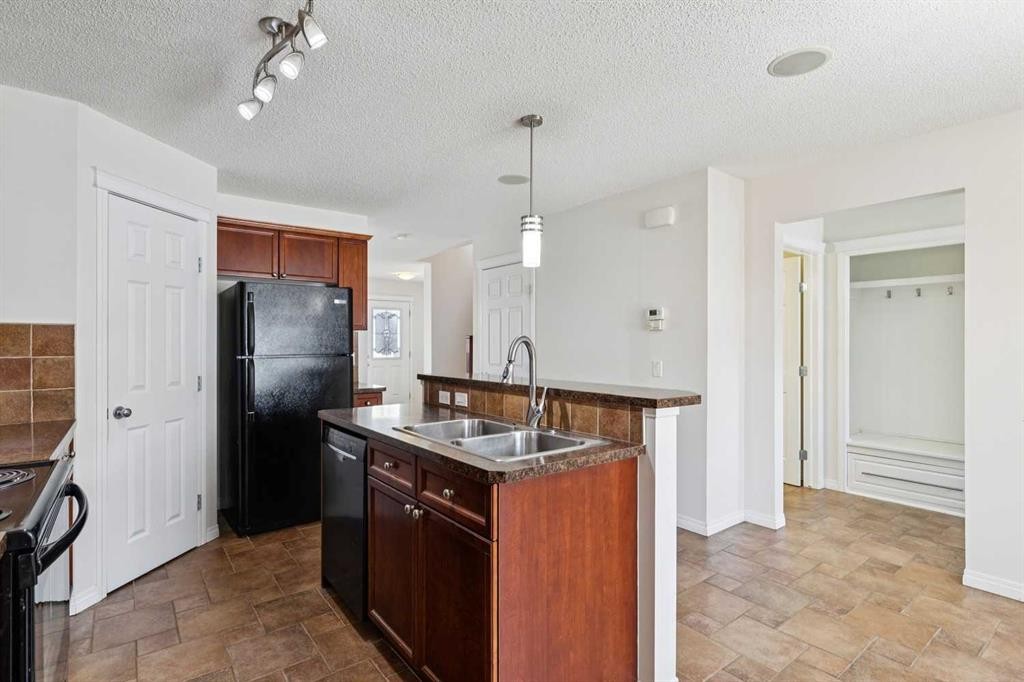 200 Silverado Drive Sw, Calgary, AB - Indoor Photo Showing Kitchen With Double Sink