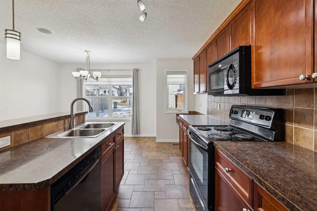 200 Silverado Drive Sw, Calgary, AB - Indoor Photo Showing Kitchen With Double Sink