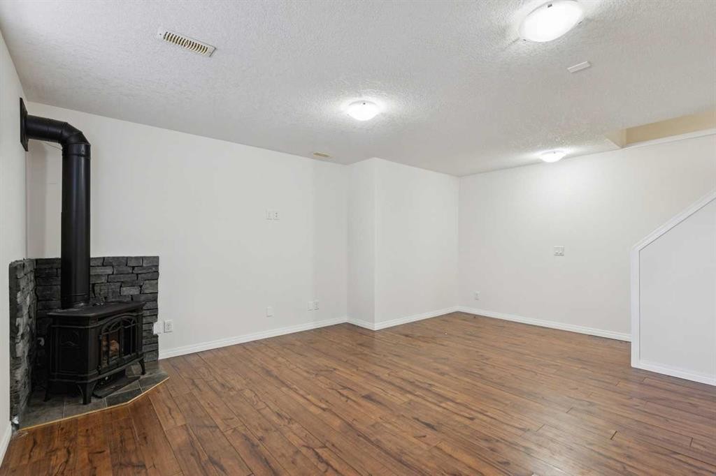 200 Silverado Drive Sw, Calgary, AB - Indoor Photo Showing Other Room With Fireplace