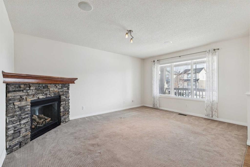 200 Silverado Drive Sw, Calgary, AB - Indoor Photo Showing Living Room With Fireplace
