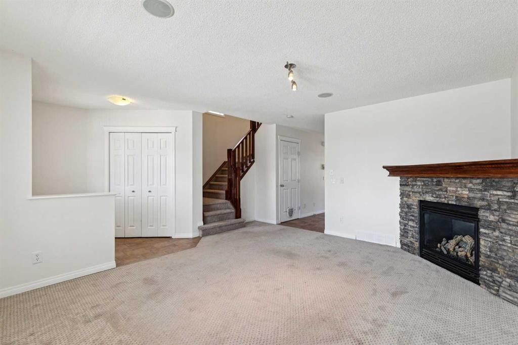 200 Silverado Drive Sw, Calgary, AB - Indoor Photo Showing Other Room With Fireplace