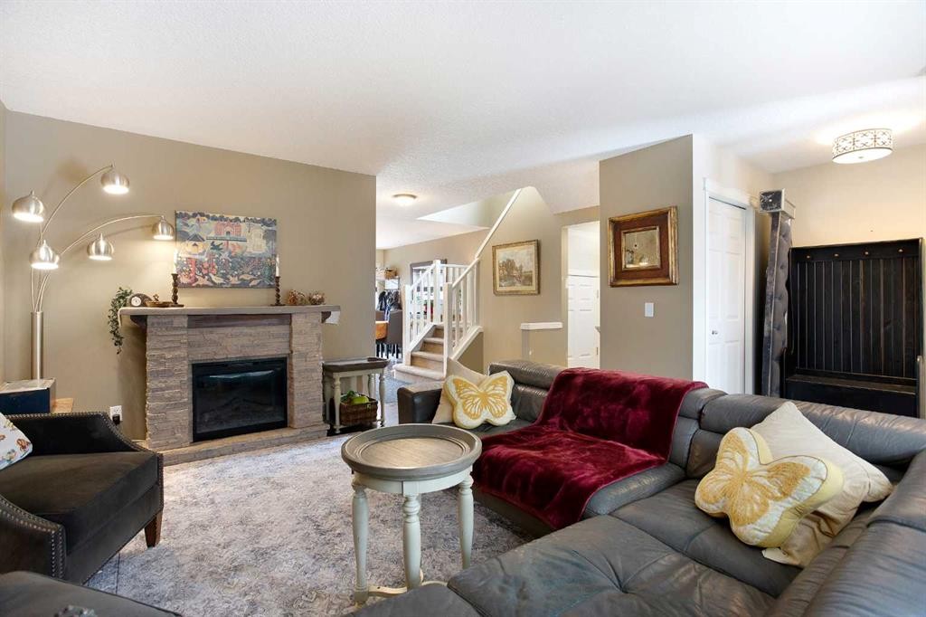 204 Eversyde Circle Sw, Calgary, AB - Indoor Photo Showing Living Room With Fireplace